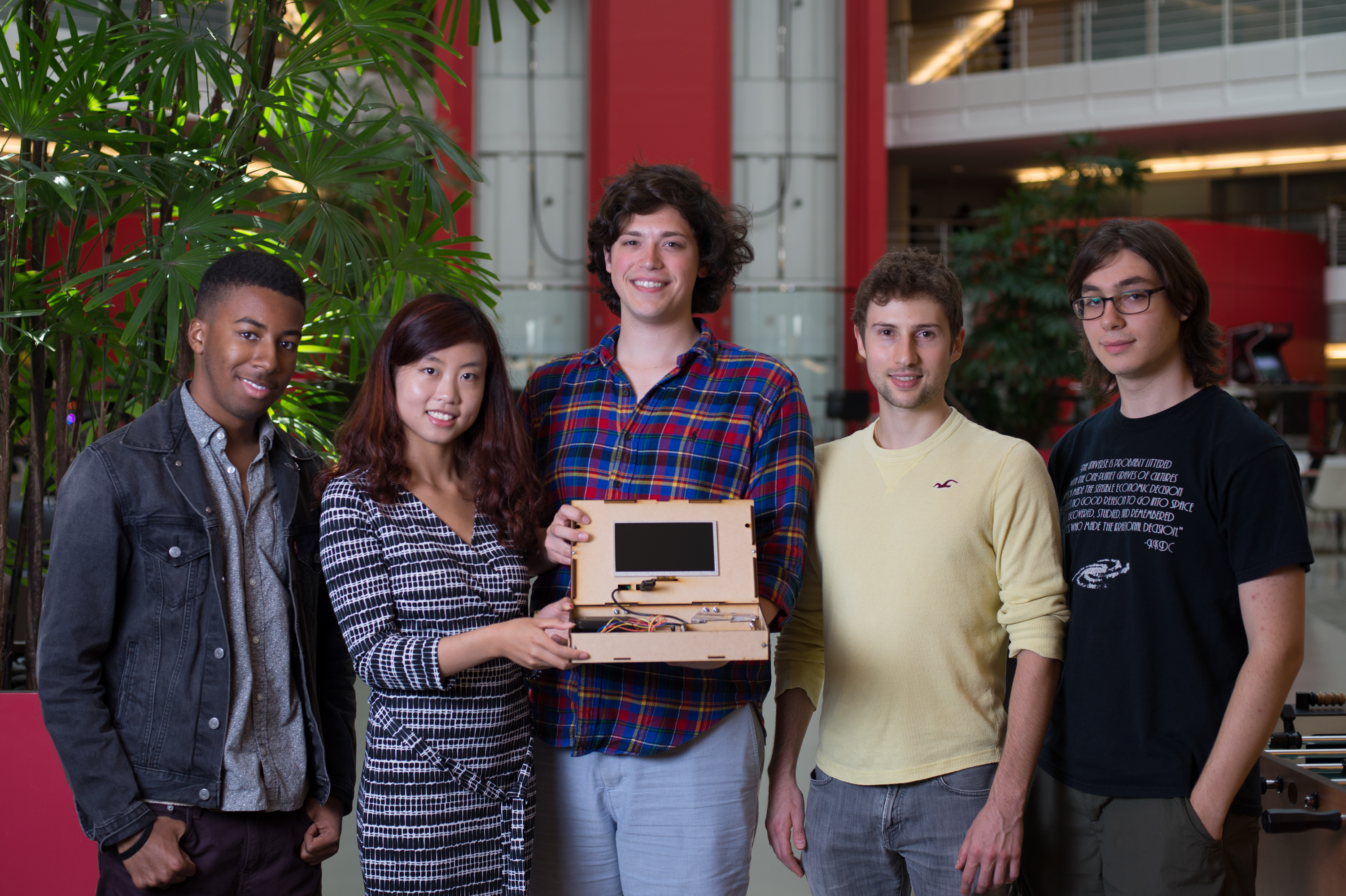 The Piper founding team holding an early wooden prototype of the Computer Kit