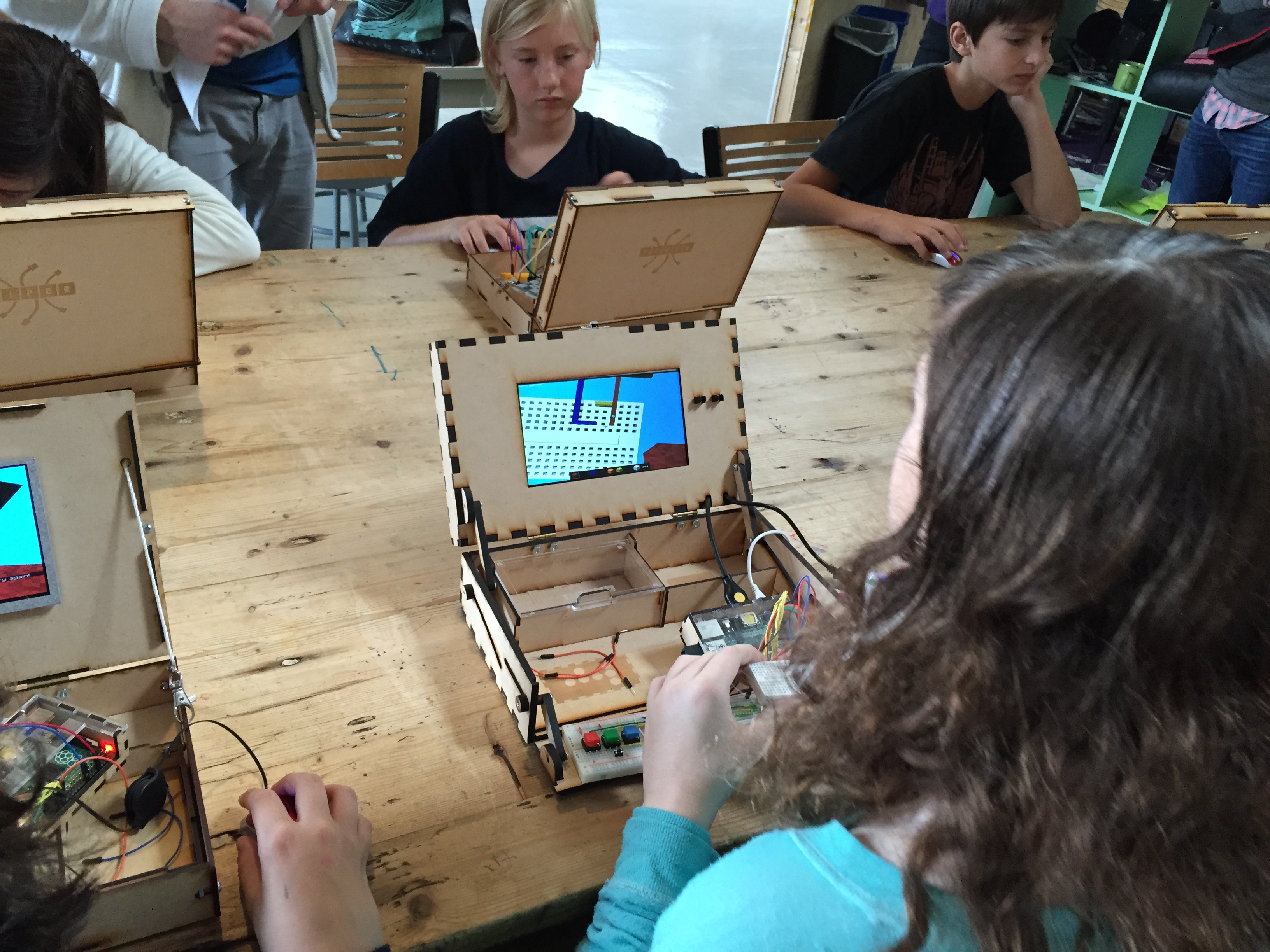 Kids testing multiple V2 wood prototypes