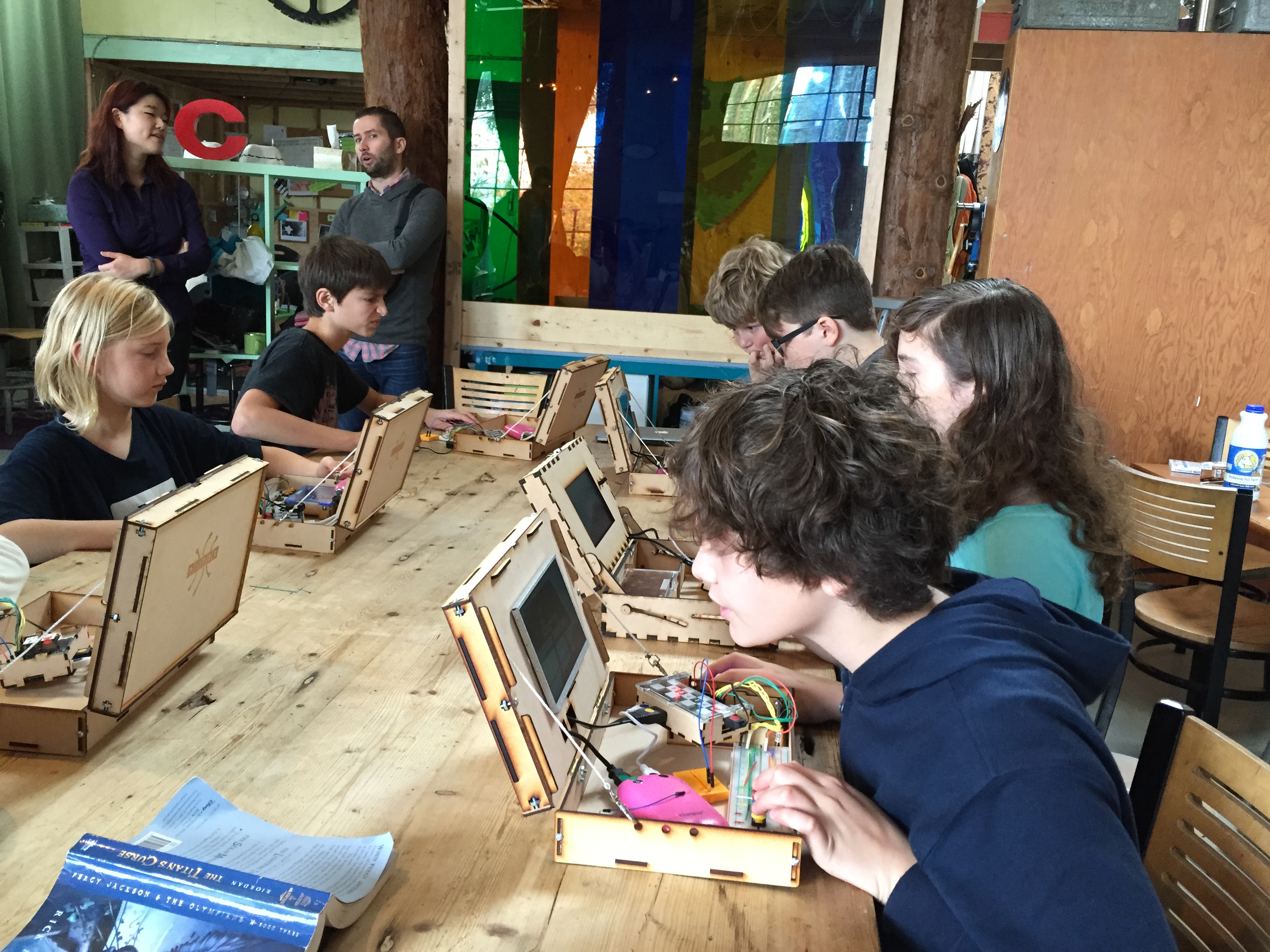 Kids testing the physical wood prototype matching the Concept 2 CAD model