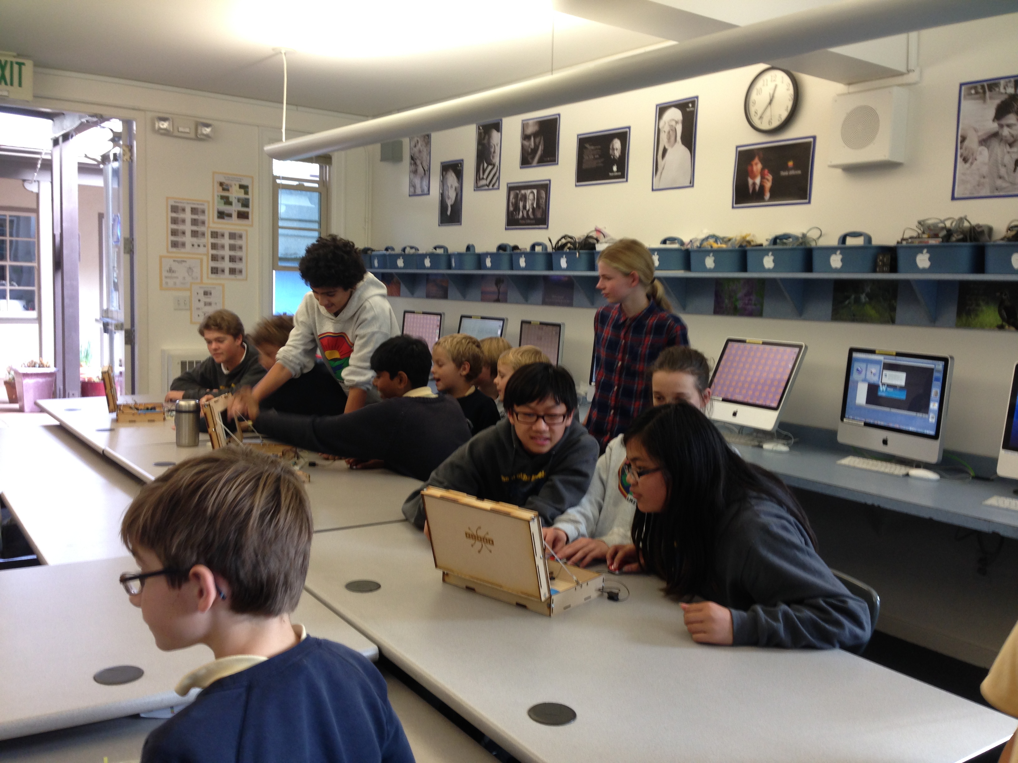 Kids in glasses testing a wired Piper prototype in a STEM classroom